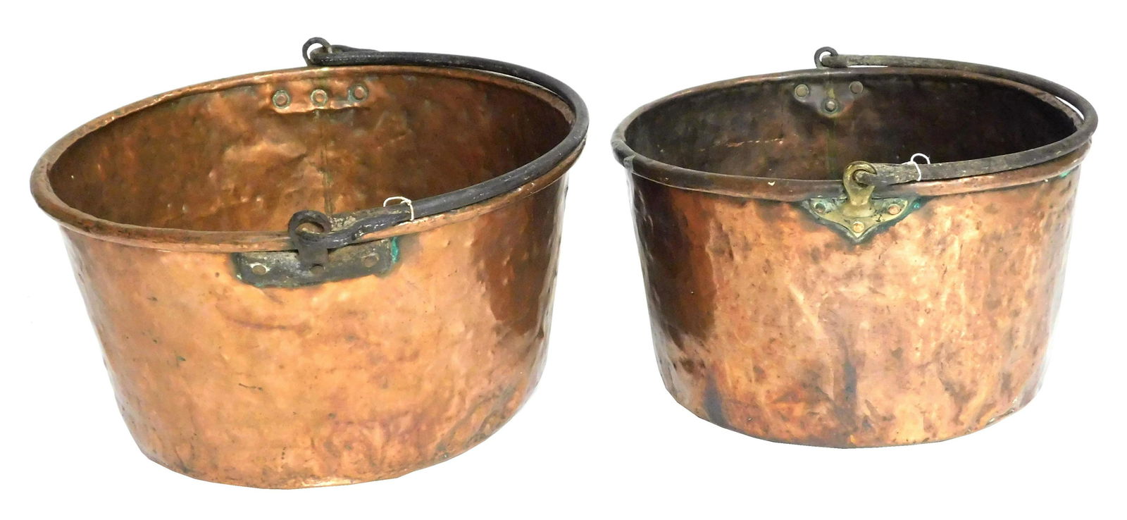 Two large, hammered copper cauldrons with iron swing handles, 19th C., wear consistent with age (1 of 1)