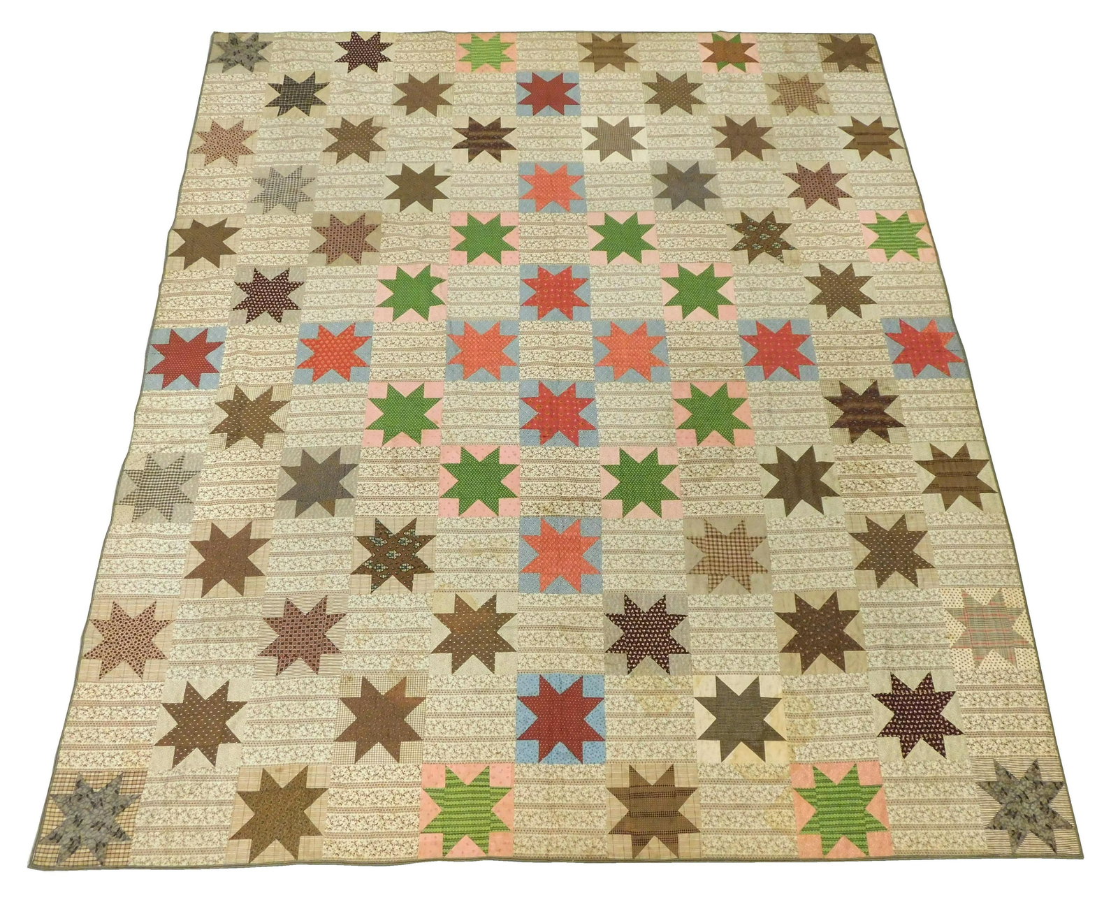 TEXTILE: Pieced calico quilt with a design of eight-pointed stars alternating with a brown and white (1 of 5)