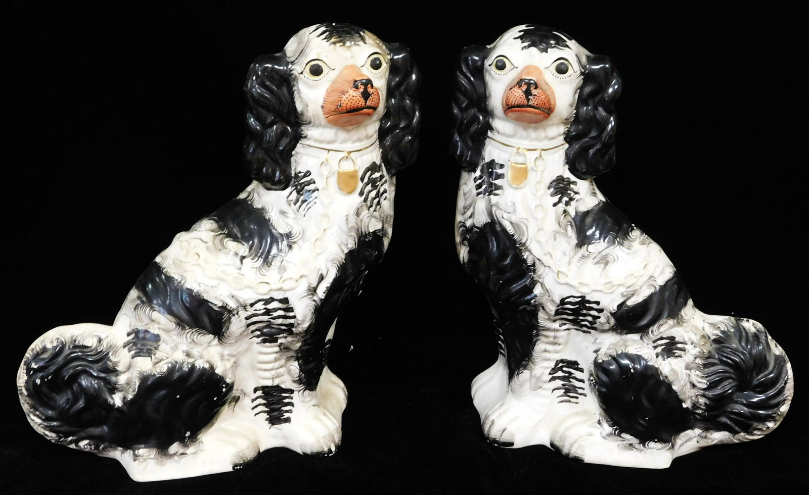 Pair of Staffordshire pottery figures of dogs, spaniel form painted in black and white with pink (1 of 5)