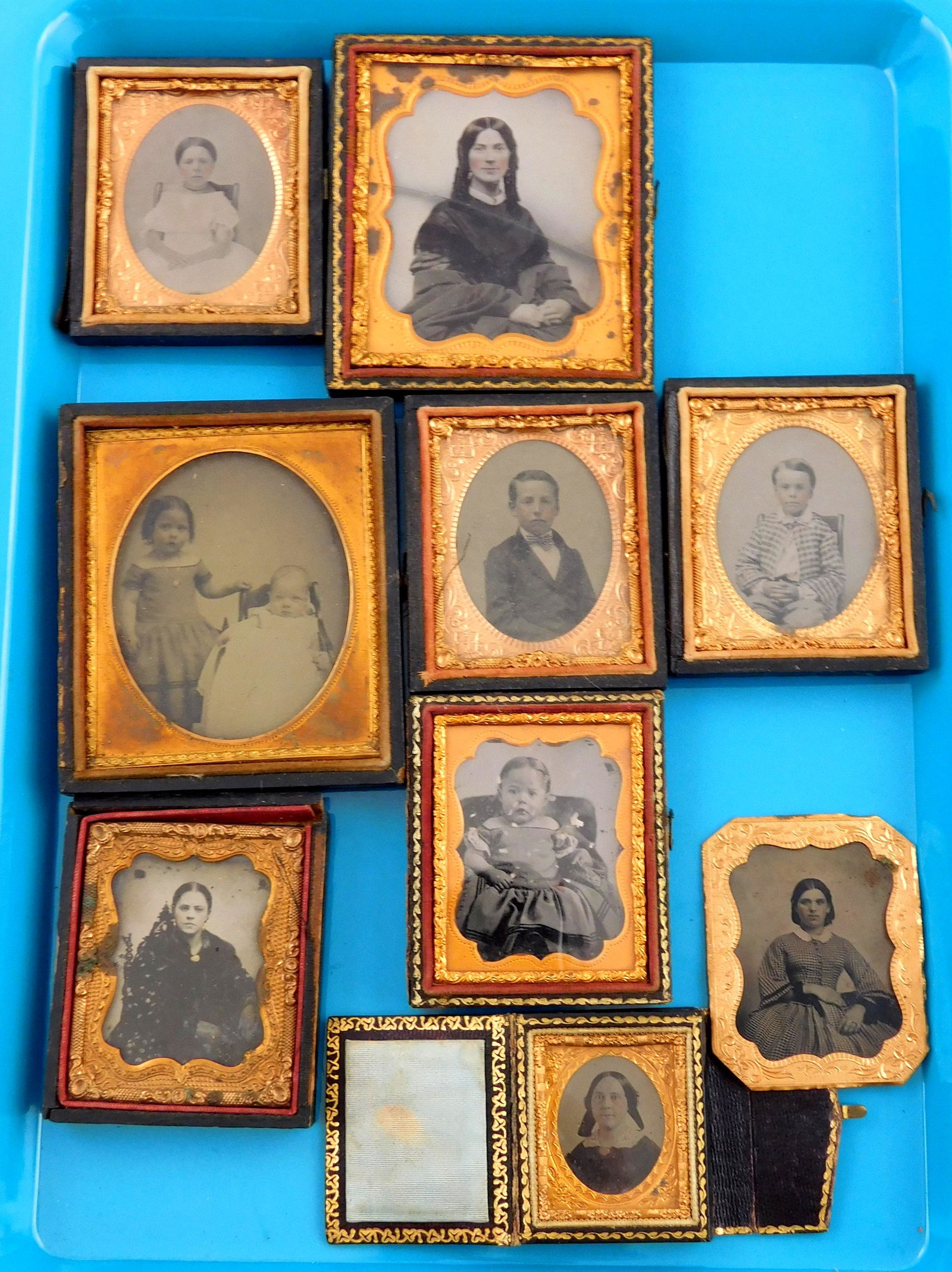 Early photography, eleven pieces: mixed assortment of tintypes and ambrotypes, all in cases, three (1 of 4)