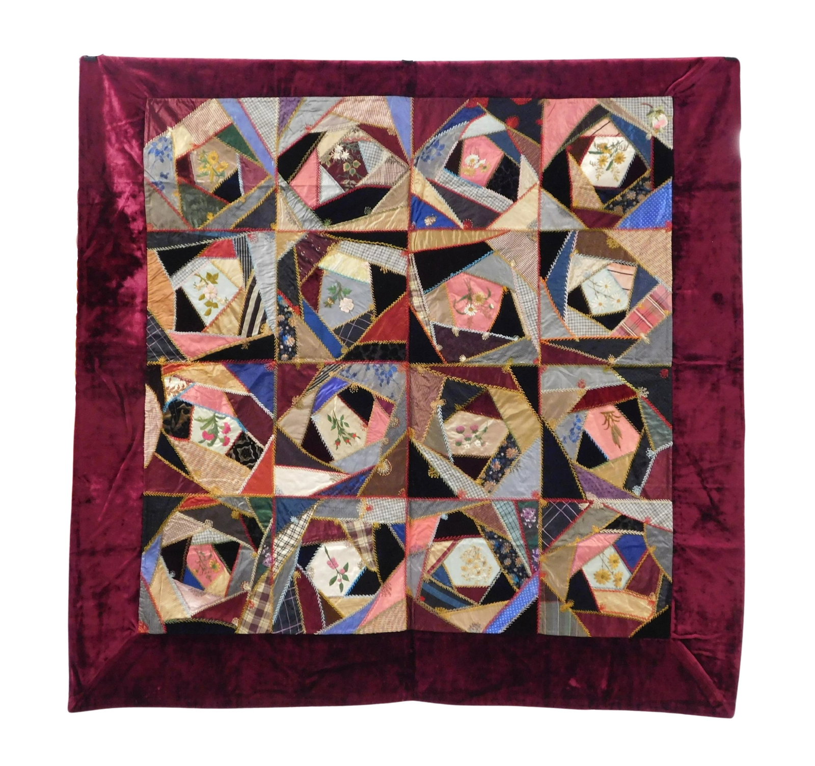 TEXTILE: 1890's Embroidered silk quilt, burgundy border, sixteen colorful squares, each one with: TEXTILE: 1890's Embroidered silk quilt, burgundy border, sixteen colorful squares, each one with flower at center, wear consistent with age including visible stitching, overall good conditon, 4' 4" x 