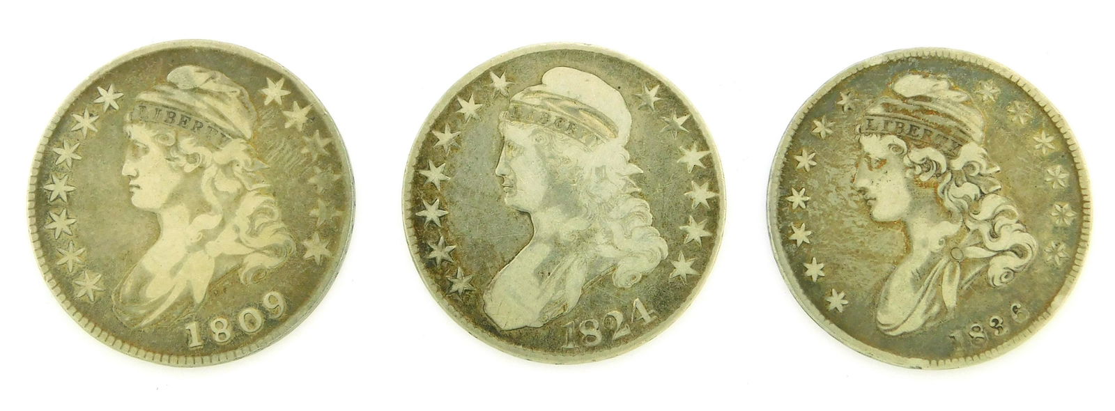 COINS: Lot of three bust half dollars. Includes an 1809, an 1824 and an 1836 lettered eadge. (1 of 2)