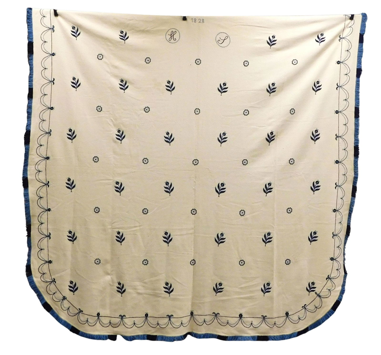 TEXTILES: Cream-colored, twill-woven wool blanket, seamed up the center. It is embroidered with wool (1 of 3)