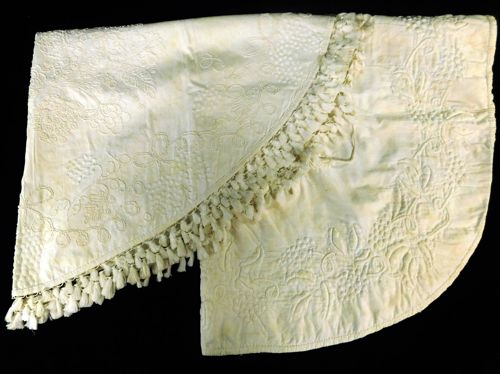 TEXTILES: Two c. 1820's demilune white work table covers: one candlewick with cornucopia and tassels (1 of 4)