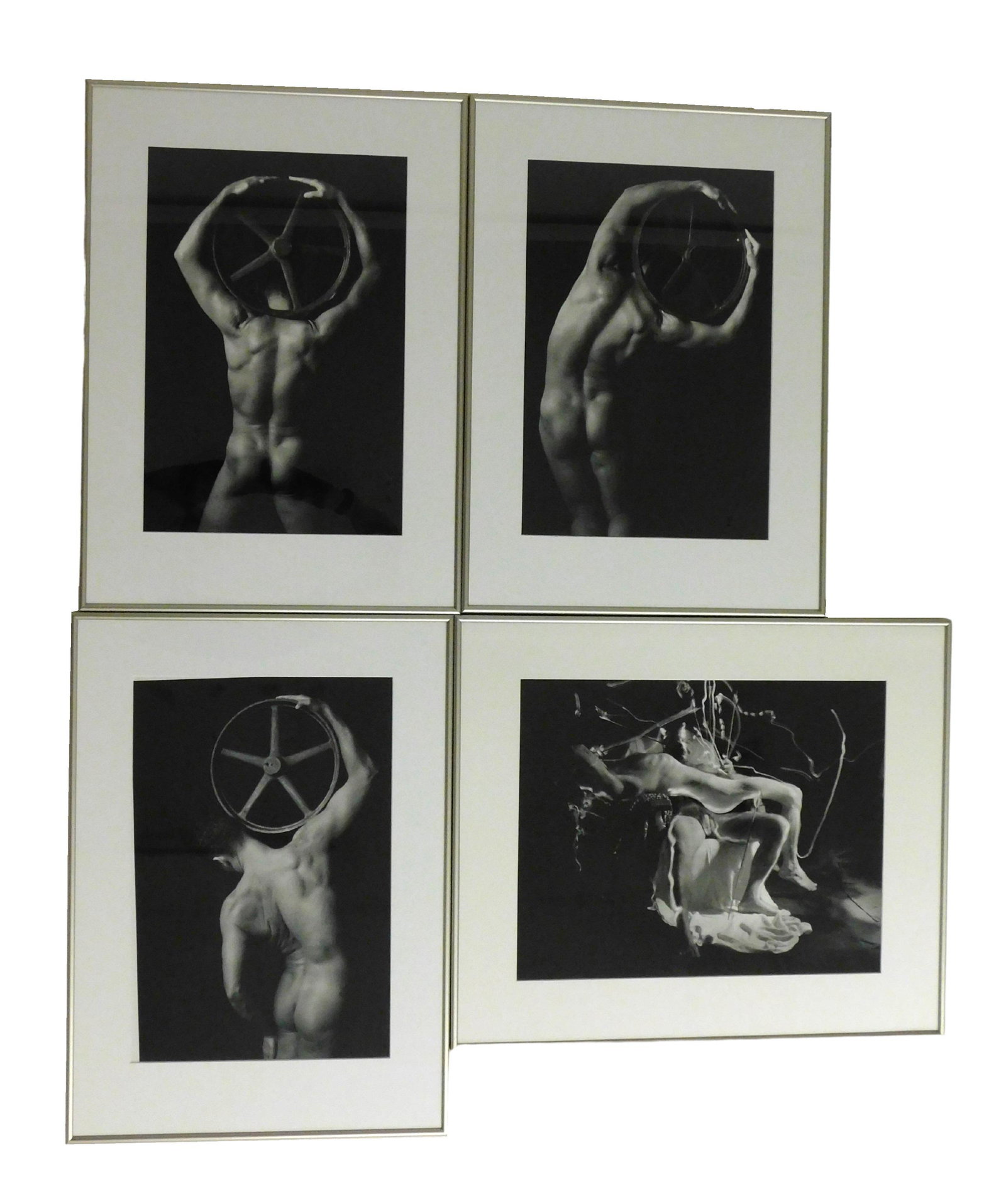 Roger Crossgrove (American, 1921 - 2016), four framed gelatin silver prints, three of male nude with: Roger Crossgrove (American, 1921 - 2016), four framed gelatin silver prints, three of male nude with wheel, one of two seated male nudes, none with observed signature, all matted and framed behind gla