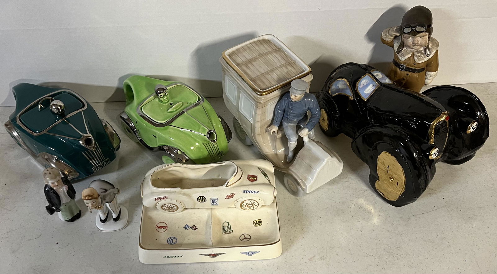 Six ceramic auto related items - two British teapots, chauffeur with early limo, sports car desk (1 of 2)