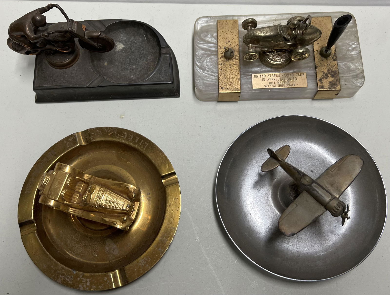 Four desk pieces, two ash trays, cast motorcycle, 7.5 lg, airplane, 7 dia, sports car trophy, 7 dia, (1 of 3)