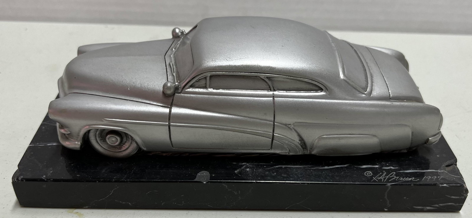 "Hirohata Mercury lead sled desk pewter sculpture, SF artist Lawrence Bruan,, this is the famous: "Hirohata Mercury lead sled desk pewter sculpture, SF artist Lawrence Bruan, this is the famous Barris brothers custom that recently sold for $2 M, VG condition".
