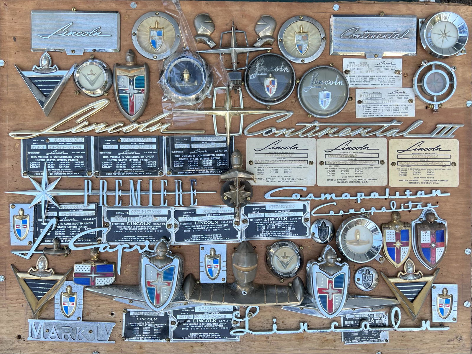1950’s Lincoln badge, data plate, etc. collection - mounted on board in a glass case, 28 x 24, all (1 of 2)