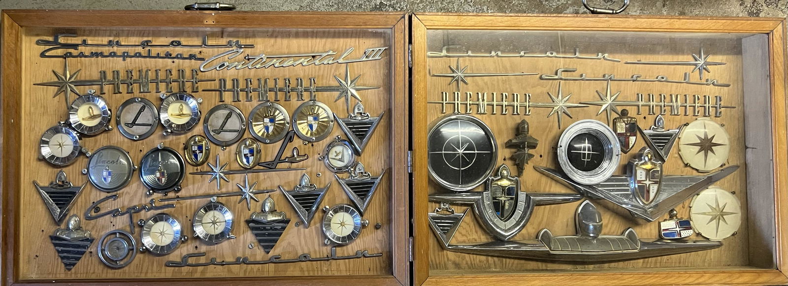 1950’s Lincoln badges and scripts collection, mounted under glass in a double folding case, 53 long (1 of 4)