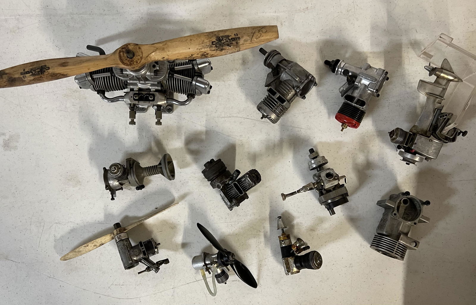 Collection of model powered gas engines - twin cylinder with prop, outboard motor, etc, some may be (1 of 2)