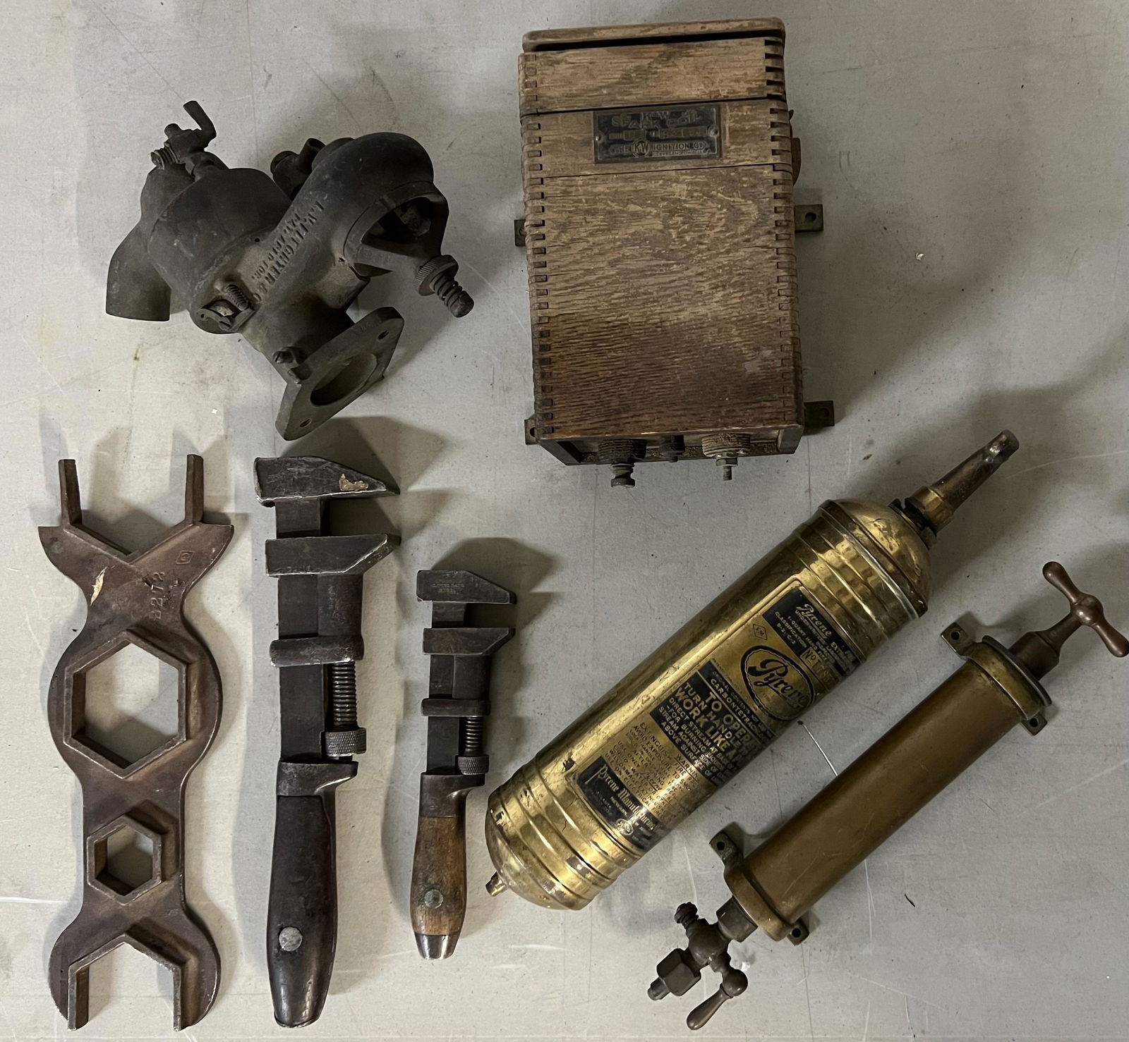 Collection of brass era items - Pyrene fire extinguisher, pressure pump, KW box, two coils, L V (1 of 3)