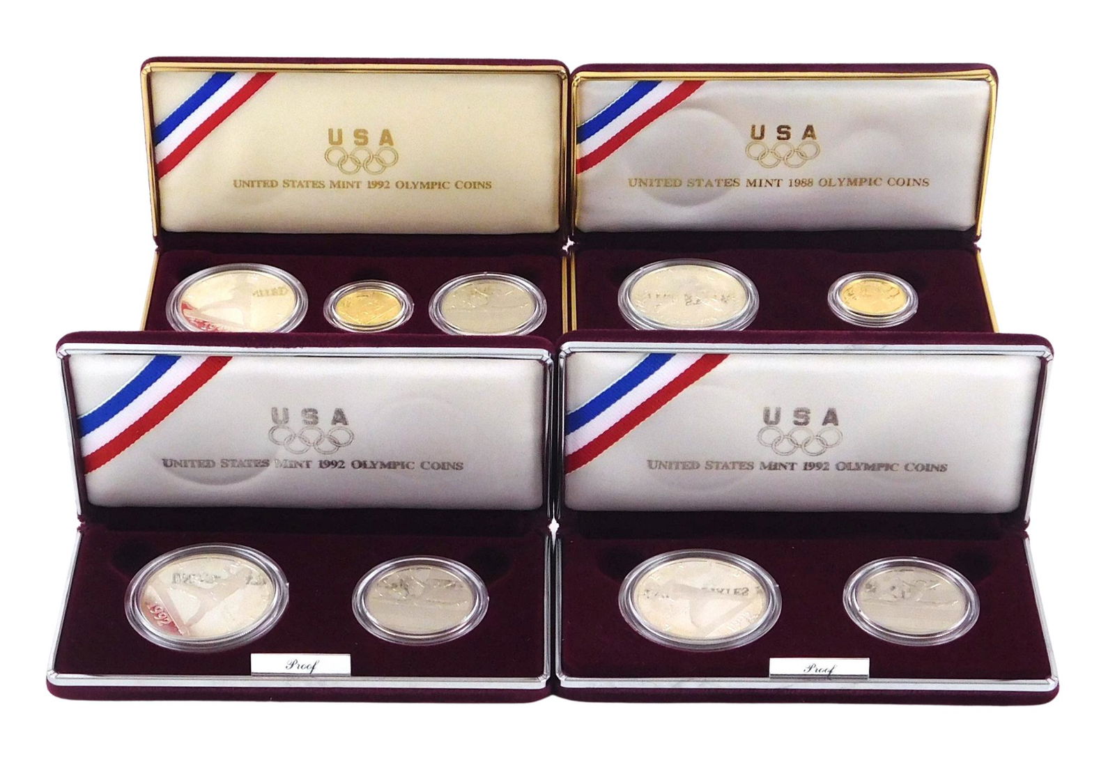 COINS: Four U.S. Mint Olympic related sets including a 1988 Olympic two-coin set, $1 silver coin and (1 of 1)