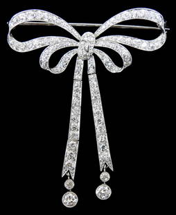 JEWELRY: Edwardian diamond bow brooch by J. E. Caldwell, tested platinum, with milgrain, containing: JEWELRY: Edwardian diamond bow brooch by J. E. Caldwell, tested platinum, with milgrain, containing 102 old European cut diamonds with an estimated combined weight of 2.68 carats, F-G/VS2-SI2, tradema