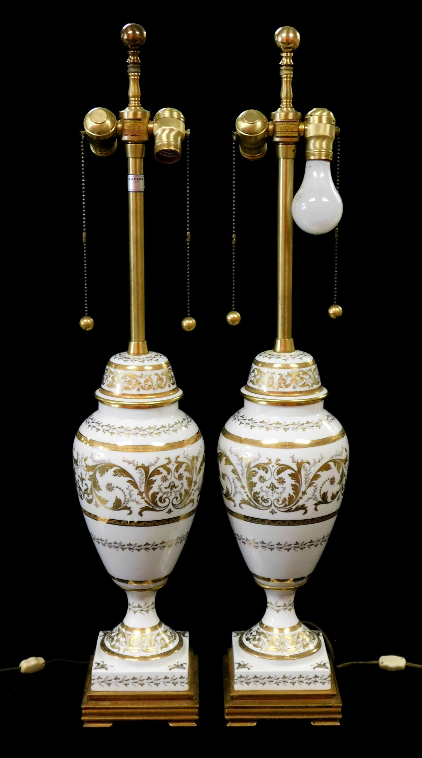 LAMPS: Matching pair of Marbro Co. table lamps, 20th C., gilt and white porcelain urn form on square (1 of 3)