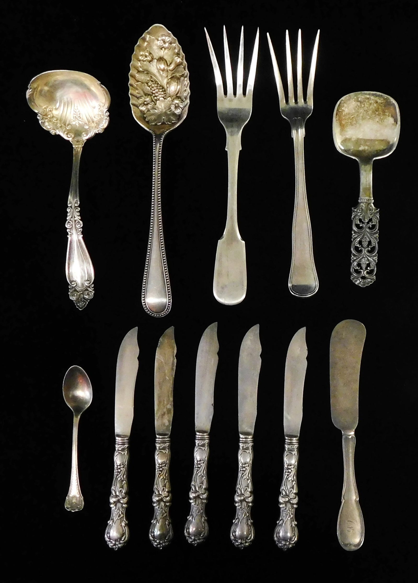 SILVER: Twelve pieces of silverware, all tested silver, including: two serving spoons; two serving (1 of 3)