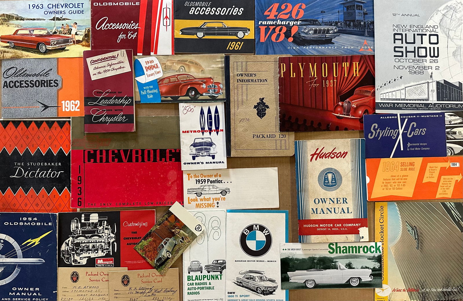 Mixed 1930’s-1970’s automobilia lot - manuals, brochures, postcards, jacket patches, (1 of 4)
