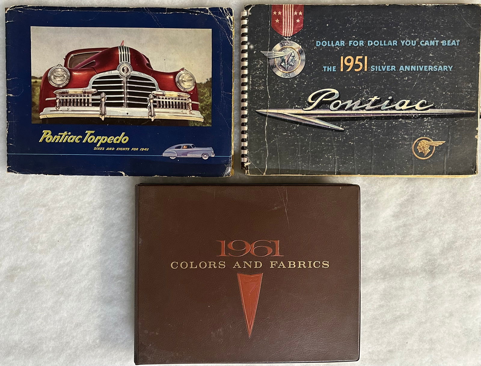 Three Pontiac dealer albums - 1942 and 1951 full line some cover and page edge wear - 1961 Colors (1 of 3)