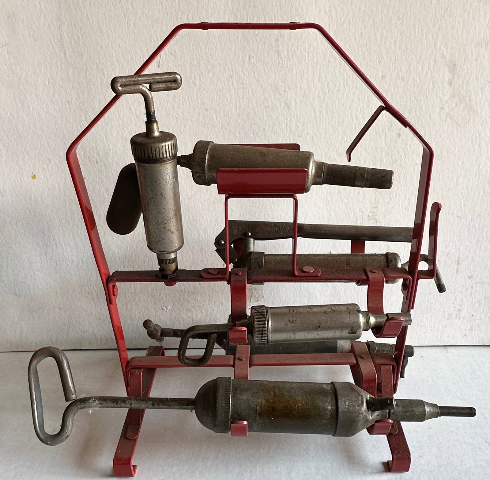 Grease gun display rack for a repair garage, Graco Model CJ500 Four In One, unique vintage garage: Grease gun display rack for a repair garage, Graco Model CJ500 Four In One, unique vintage garage display, vg condition, 14 wide, 16 high [NOTE: SHIPPING AND PICK UP APPOINTMENTS ARE HANDLED EXCLUSIVE