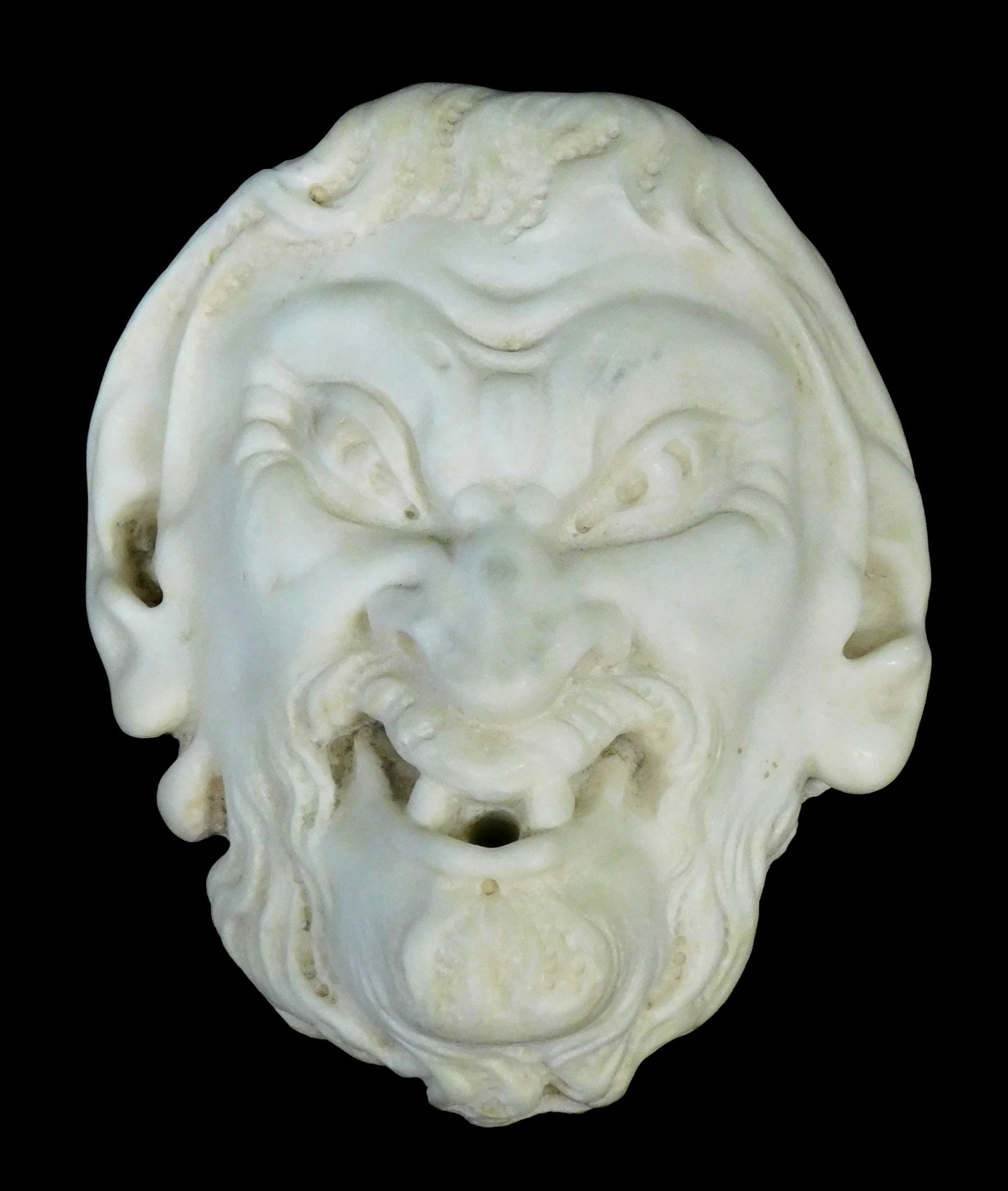 GARDEN: Carved white marble satyr face, possibly from a fountain, depicting an angry satyr with (1 of 5)