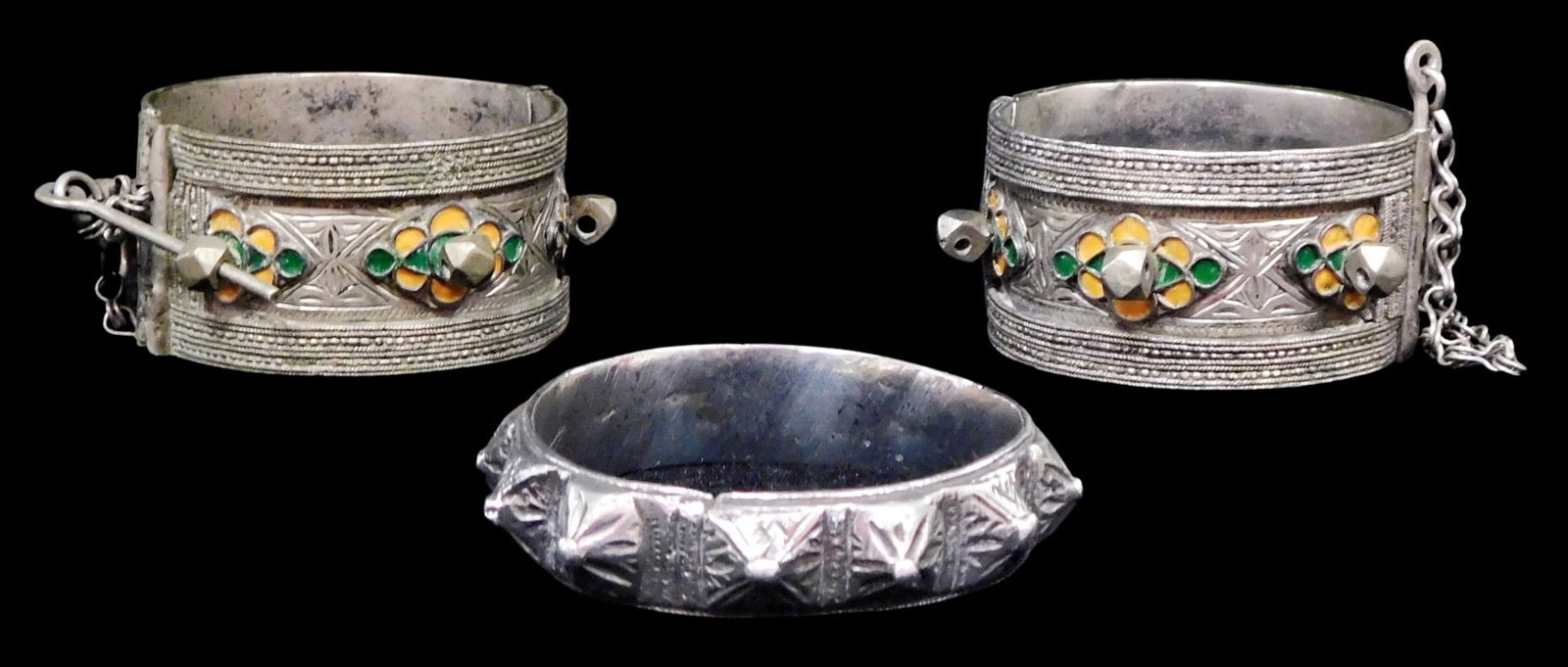 JEWELRY: Three tested silver bracelets, 20th C., including: two Middle Eastern style pin locking (1 of 3)