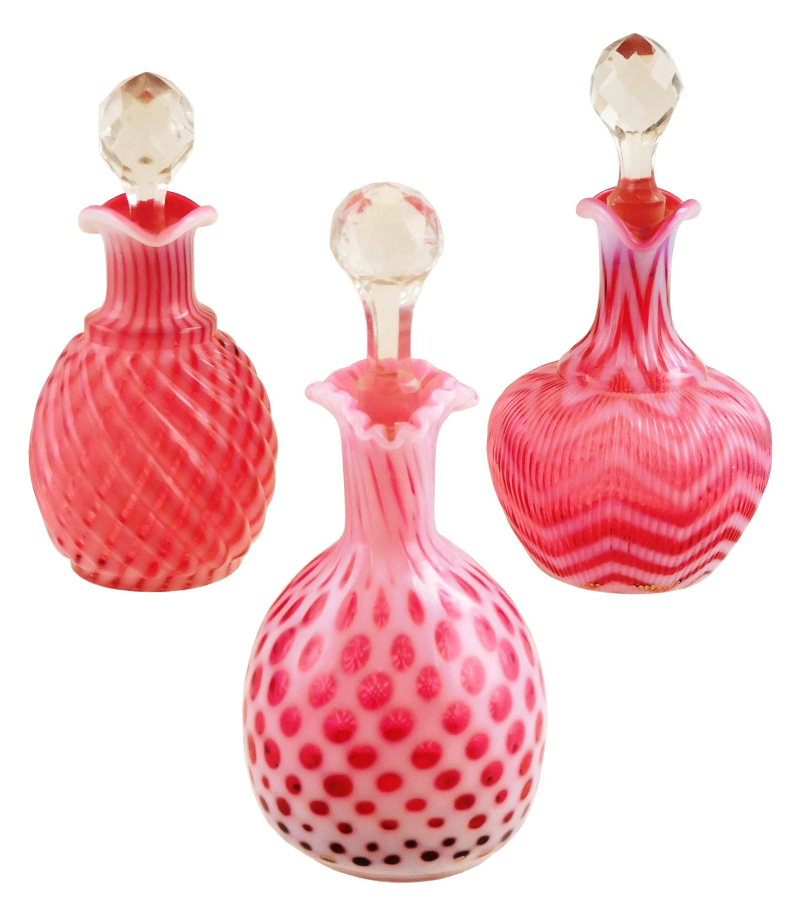 ART GLASS: Three cranberry opalescent glass cruets, each with opalescent designs and cut glass (1 of 2)
