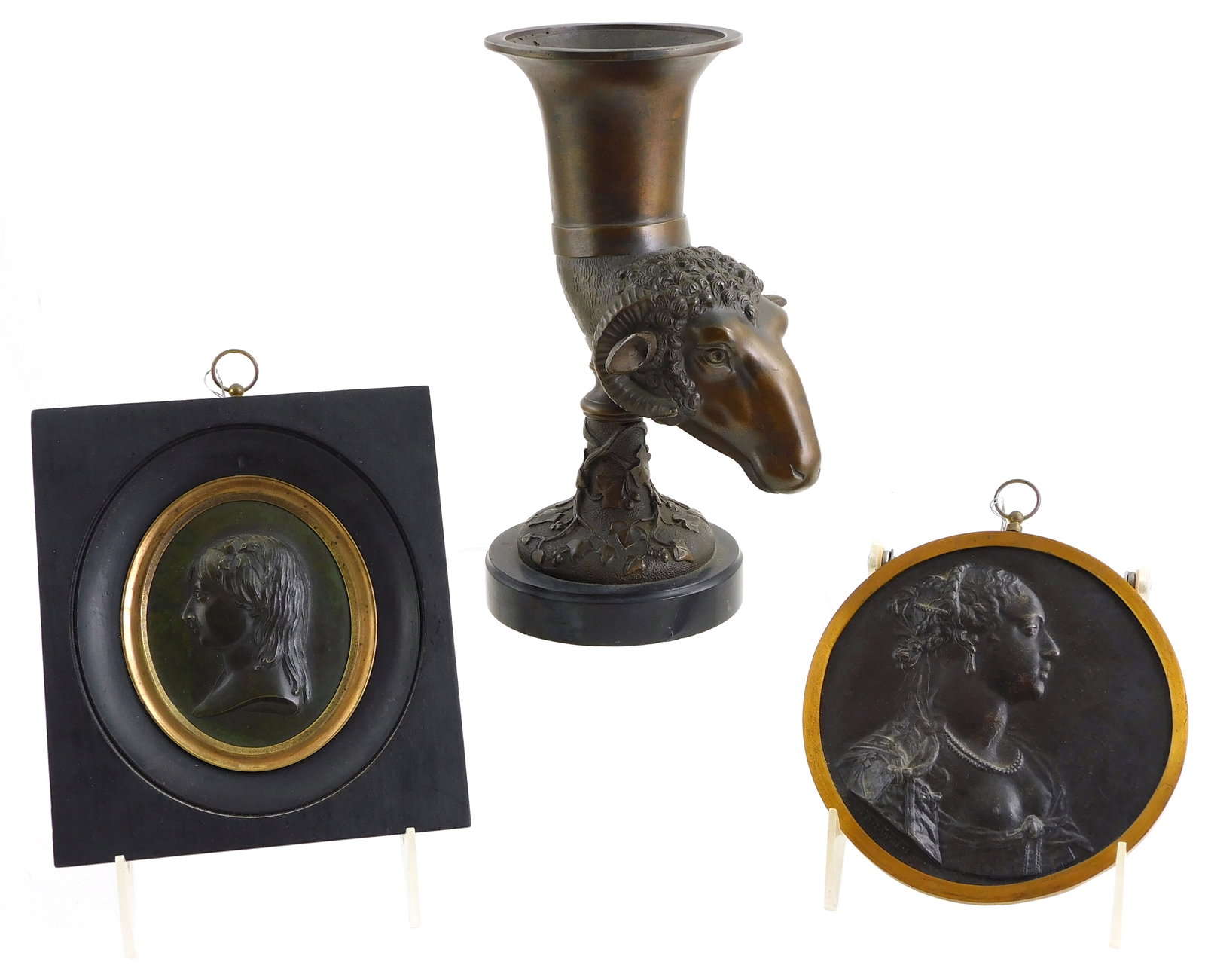 Continental metalware, three pieces, including: rams head cup/ vase on foot, mounted on stone base, (1 of 2)