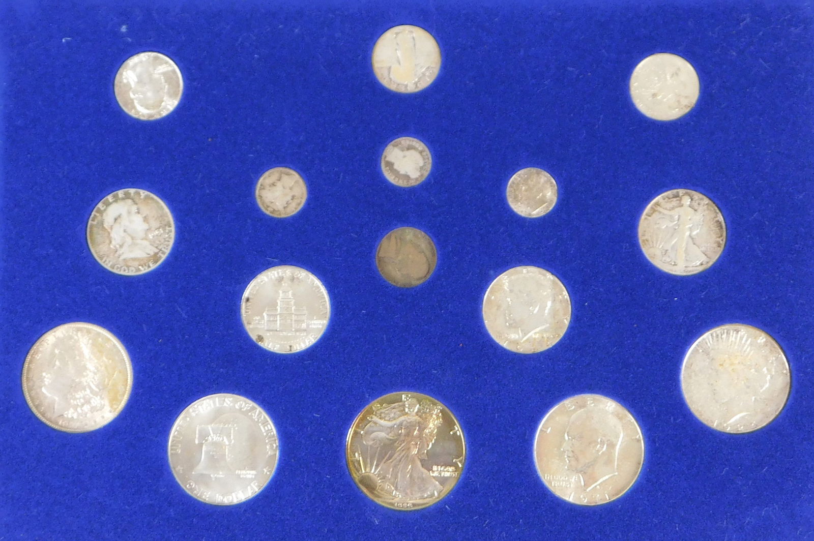 COINS: "100 Years of US Silver Coinage", wooden display box (slightly damaged) containing 16 various (1 of 4)