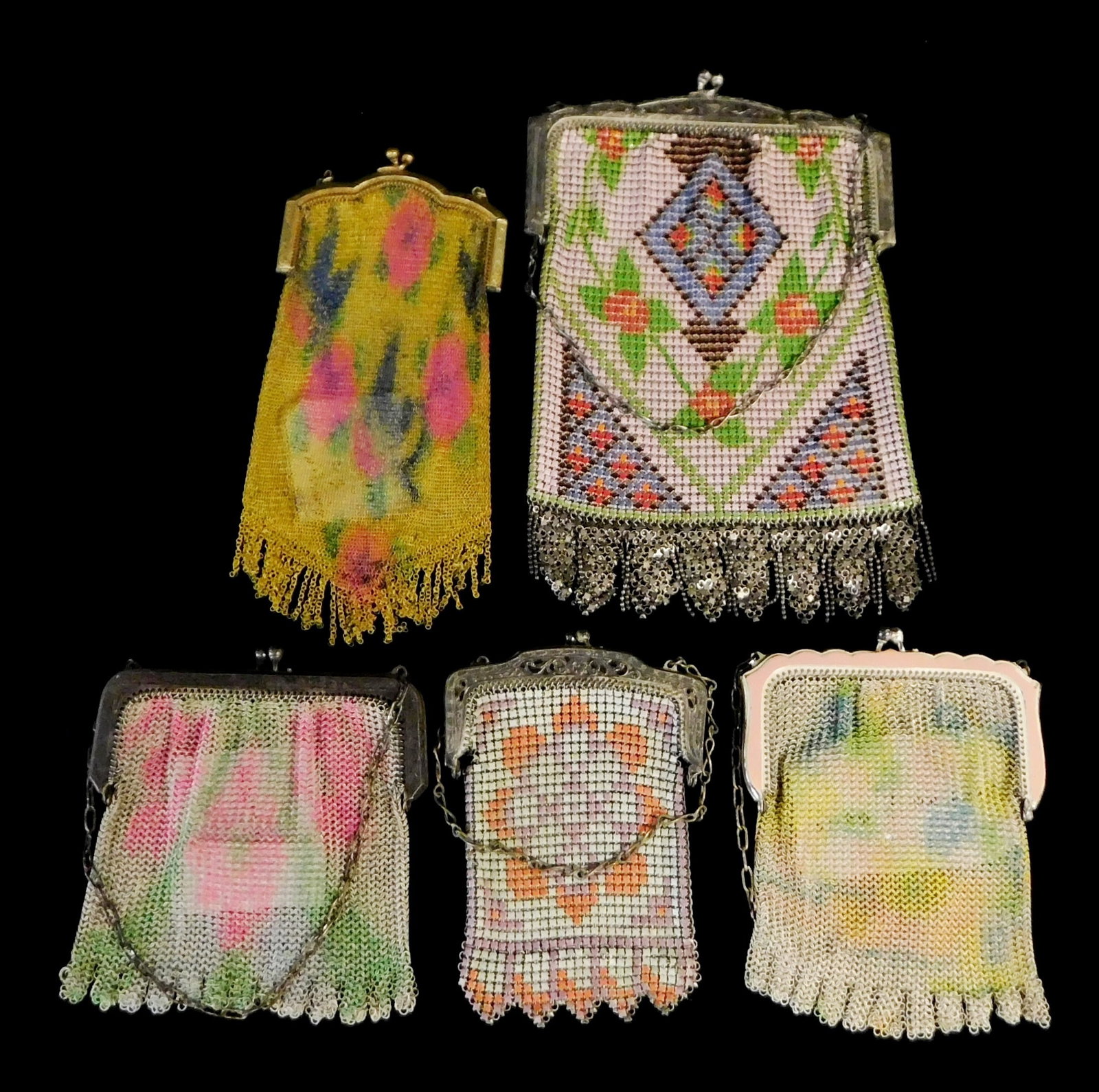 VINTAGE: Five Whiting Davis mesh purses, American, 20th C., all with colored patterns and chain: VINTAGE: Five Whiting Davis mesh purses, American, 20th C., all with colored patterns and chain straps, one with enamel accents, four others with etched floral decoration, all with maker's marks, wear