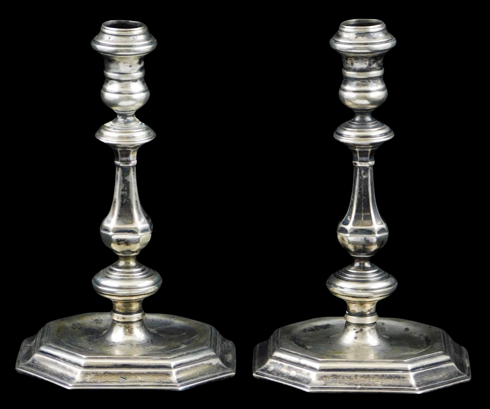 SILVER: Pair of tested silver candlesticks, each with octagonal bases, shaped stems, rubbed: SILVER: Pair of tested silver candlesticks, each with octagonal bases, shaped stems, rubbed indistinct hallmarks to base, wear consistent with age and use, including damage and repairs, each: 7 1/4" h