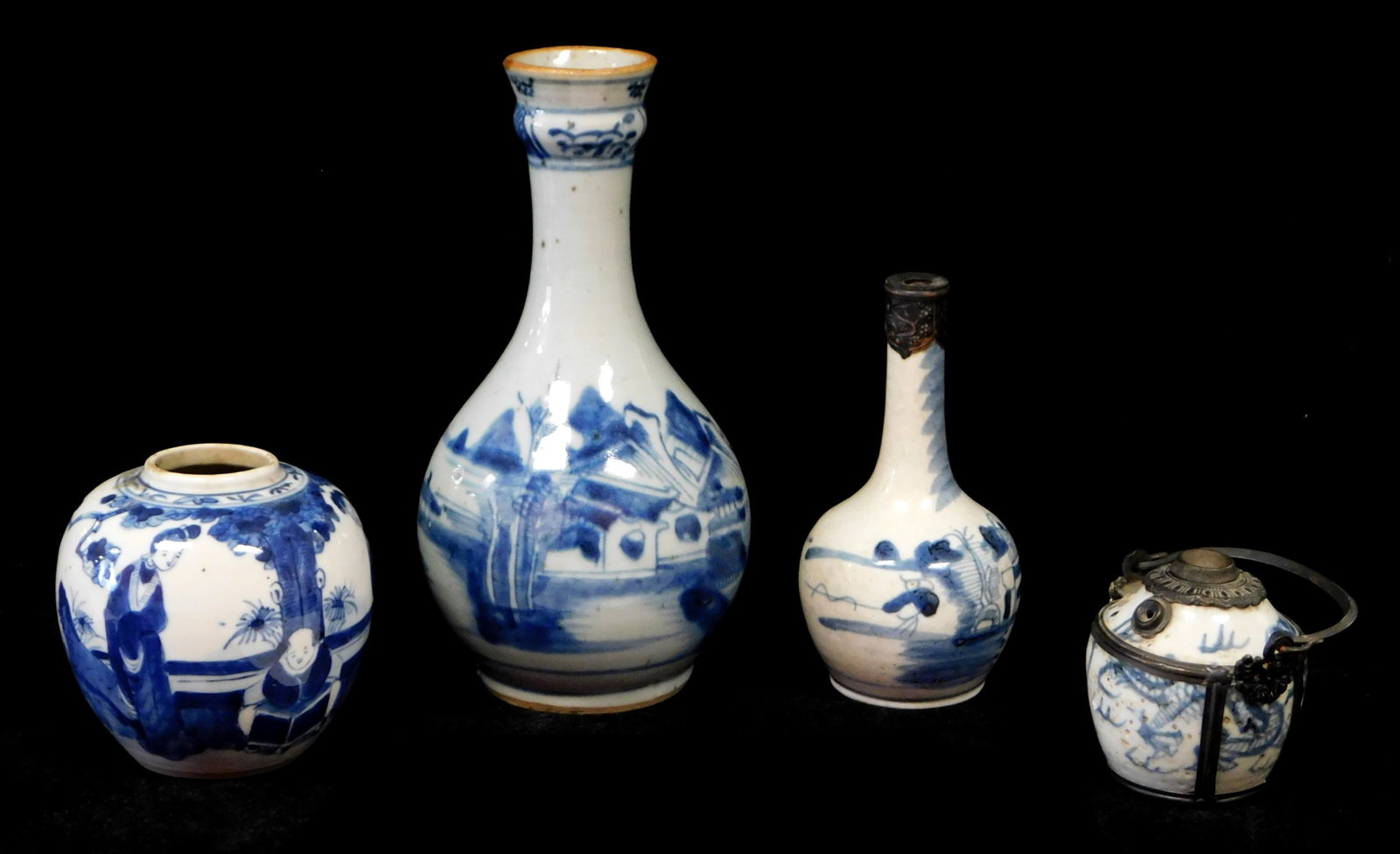 ASIAN: Four blue and white pieces of pottery hollowware, including: tallest 9" vase, one smaller: ASIAN: Four blue and white pieces of pottery hollowware, including: tallest 9" vase, one smaller vase, one small wood lid ginger jar, one container with swing handle, all with wear consistent with age