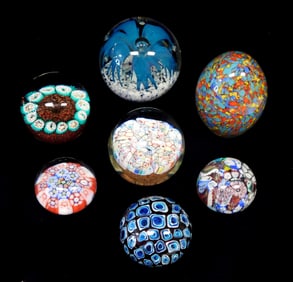 PAPERWEIGHTS: Seven decorative glass paperweights, Murano and other, four round clear with