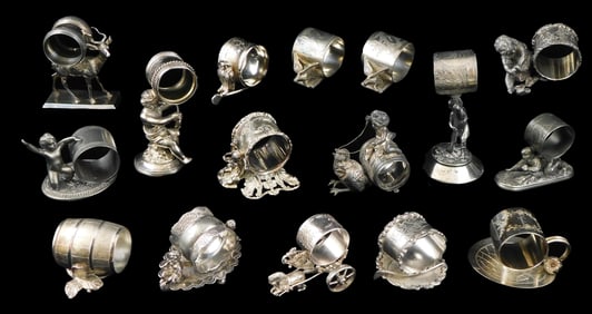 Sixteen assorted figural napkin rings, late 19th/early 20th C., silver plate and other metals, one