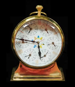 CLOCK: "World Time", 20th C, polished brass electric clock using seven battery powered movements,