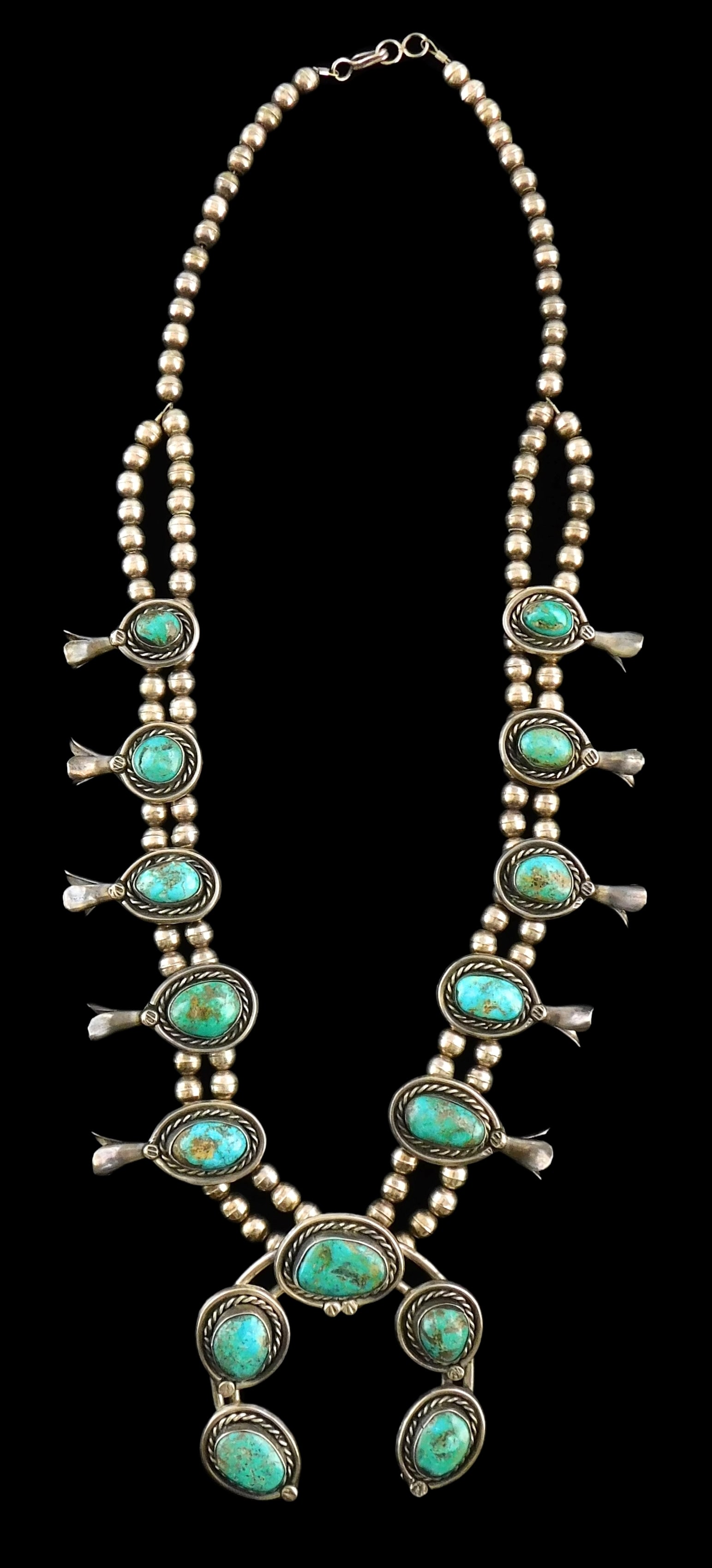 JEWELRY: Navajo style squash blossom necklace, tested silver and turquoise, 25" long from end to: JEWELRY: Navajo style squash blossom necklace, tested silver and turquoise, 25" long from end to end, double strand of silver beads, featuring ten squash blossom settings with inset turquoise cabochon