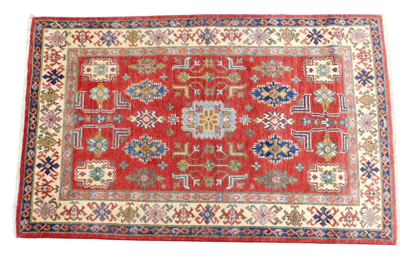 RUG: Uzbek Shirvan, 3' 10" x 6' 1", wool on cotton, center medallion on red ground, major border in (1 of 2)