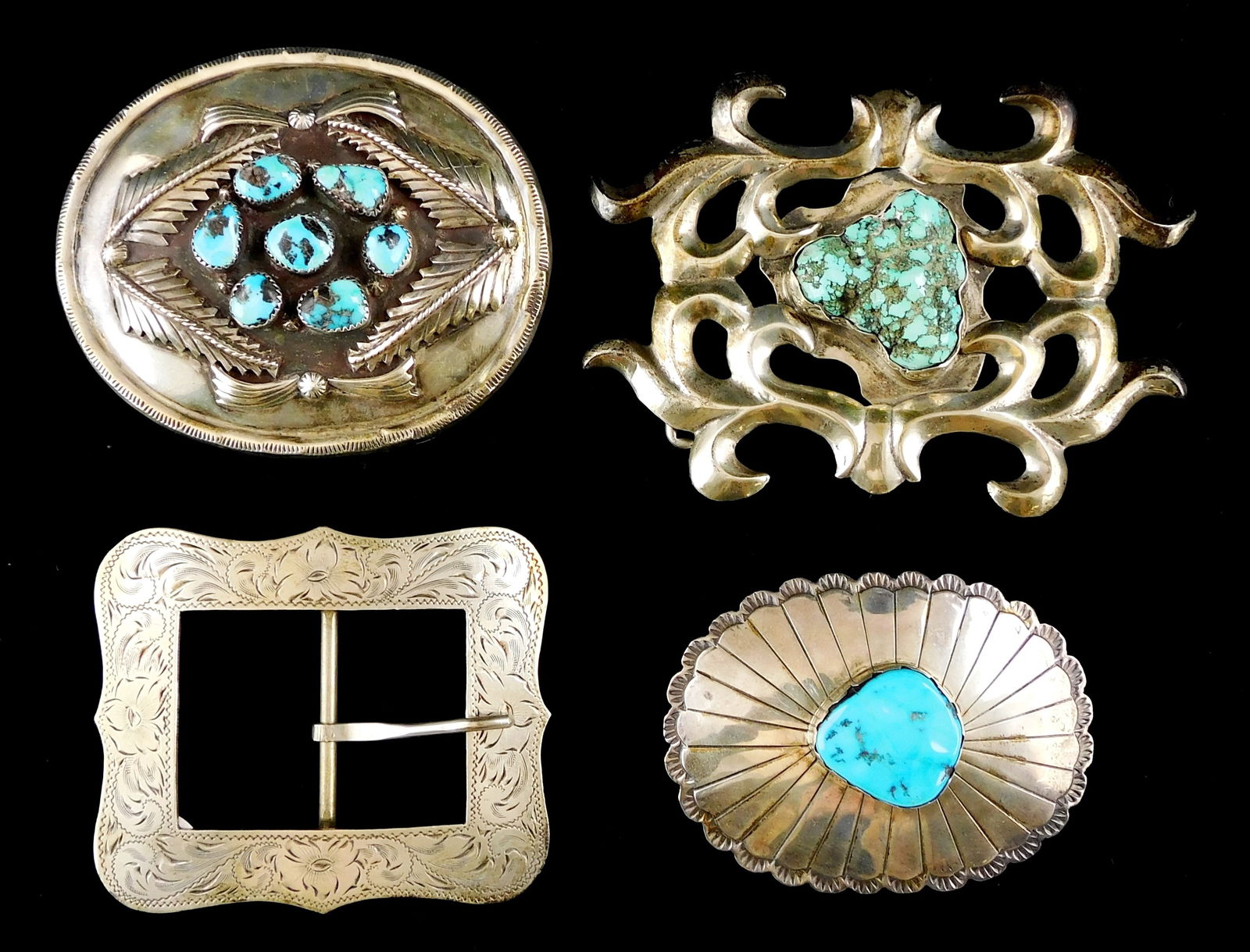 SILVER: Four silver southwest style belt buckles, the first with scrolling pattern surrounding an (1 of 7)