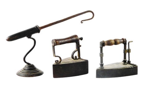 Three 19th C. irons, two box irons and a goffering iron, flat irons with wooden turned handles and