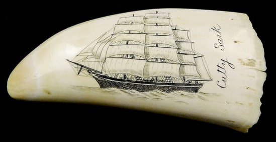 SCRIMSHAW: "Cutty Sark", engraved whale tooth depicting profile of masted ship in open waters,