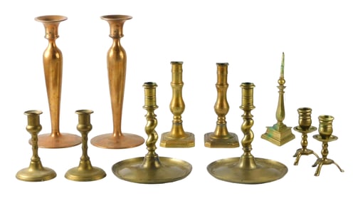 Eleven brass candlesticks, five pairs and one pricket, details include: copper-colored pair, reads