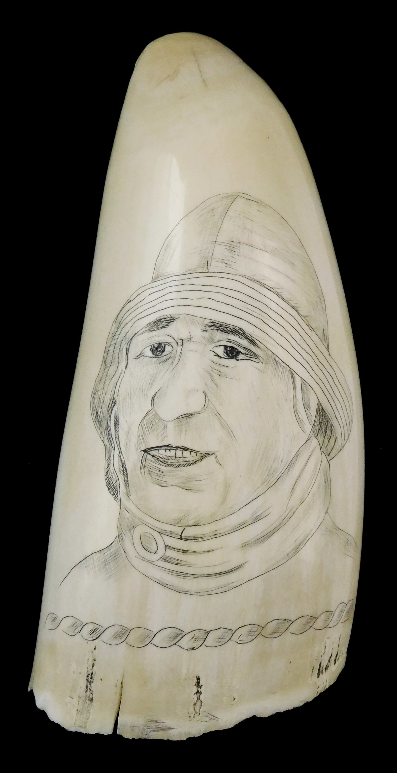SCRIMSHAW: Engraved whale tooth, portrait of seamen in cold weather gear, unsigned, wear consistent: SCRIMSHAW: Engraved whale tooth, portrait of seamen in cold weather gear, unsigned, wear consistent with age and use, age cracks to base, minor discolorations, sold as is, 4 3/4" l. [NOTE: Internation