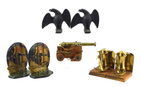 Two pair of bookends, pair of eagle-form snow guards and miniature brass cannon on cart, no maker's