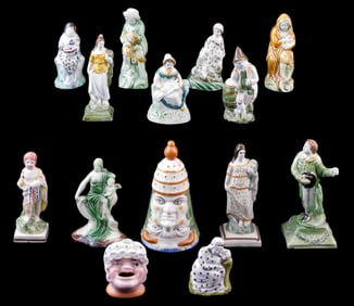 STAFFORDSHIRE: Fourteen ceramic figures and inkwell, 19th/ early 20th C., all with glazed decoration
