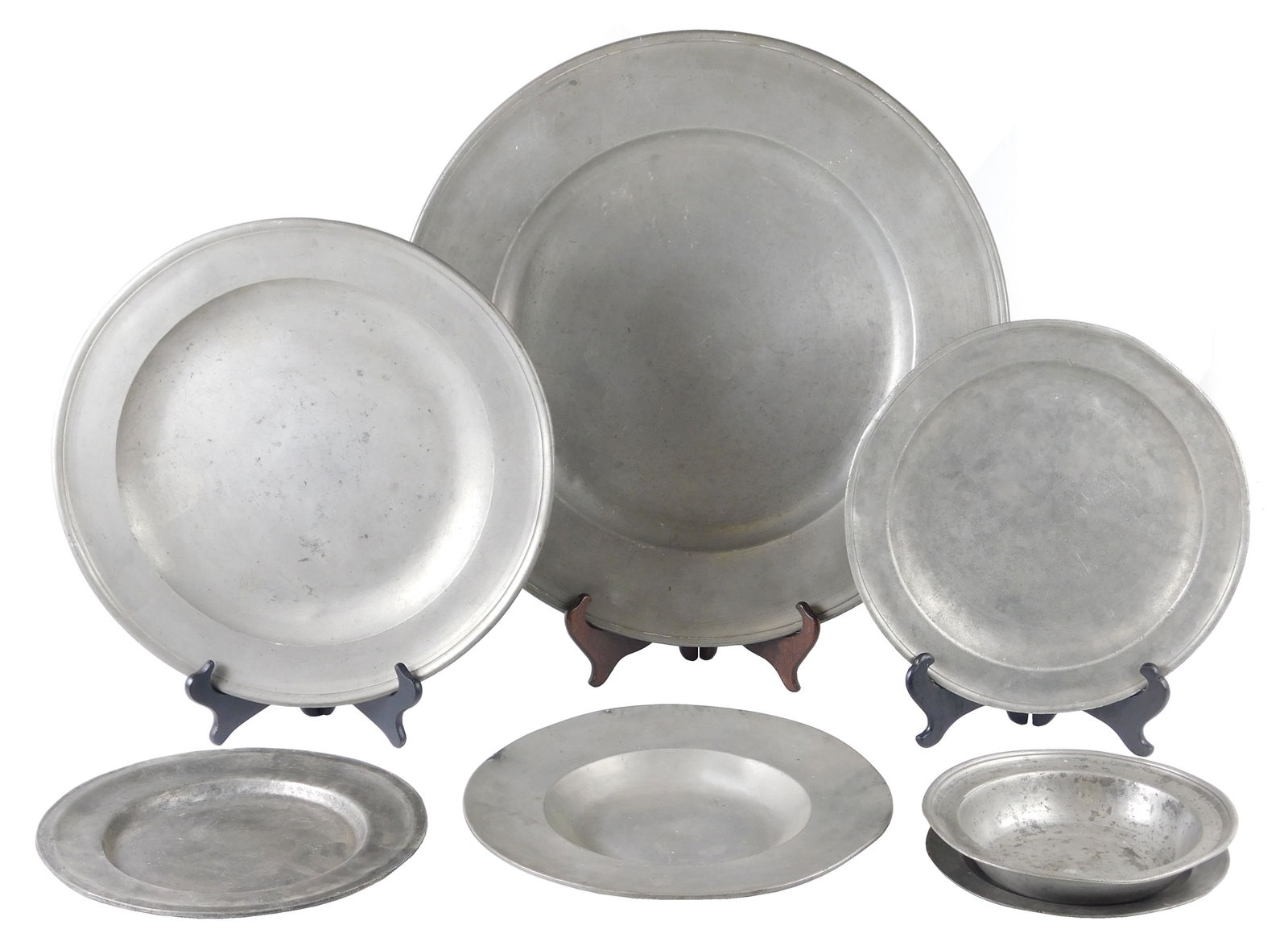 Seven assorted 18th-19th C. continental pewter chargers and dinnerware, includes: large charger with: Seven assorted 18th-19th C. continental pewter chargers and dinnerware, includes: large charger with illegible shield hallmark on the top side's lip, 19 1/2" diameter; English charger stamped with Lon