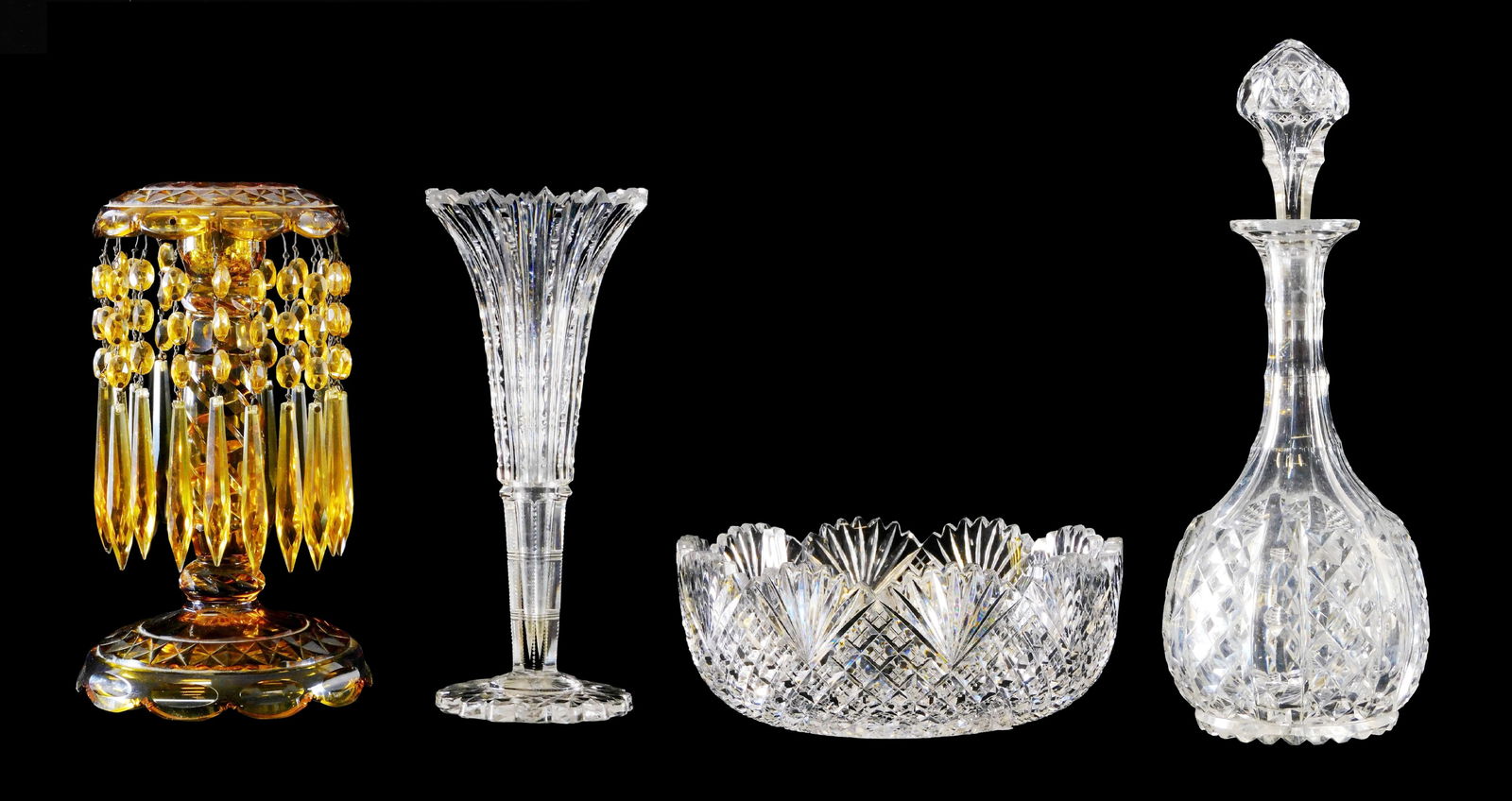 GLASS: Four pieces of cut glass, details include: amber candlestick with cut swirled stem and prisms: GLASS: Four pieces of cut glass, details include: amber candlestick with cut swirled stem and prisms hanging from scalloped rim, top and foot with large diamond cut design, wax residue, 10” h.;