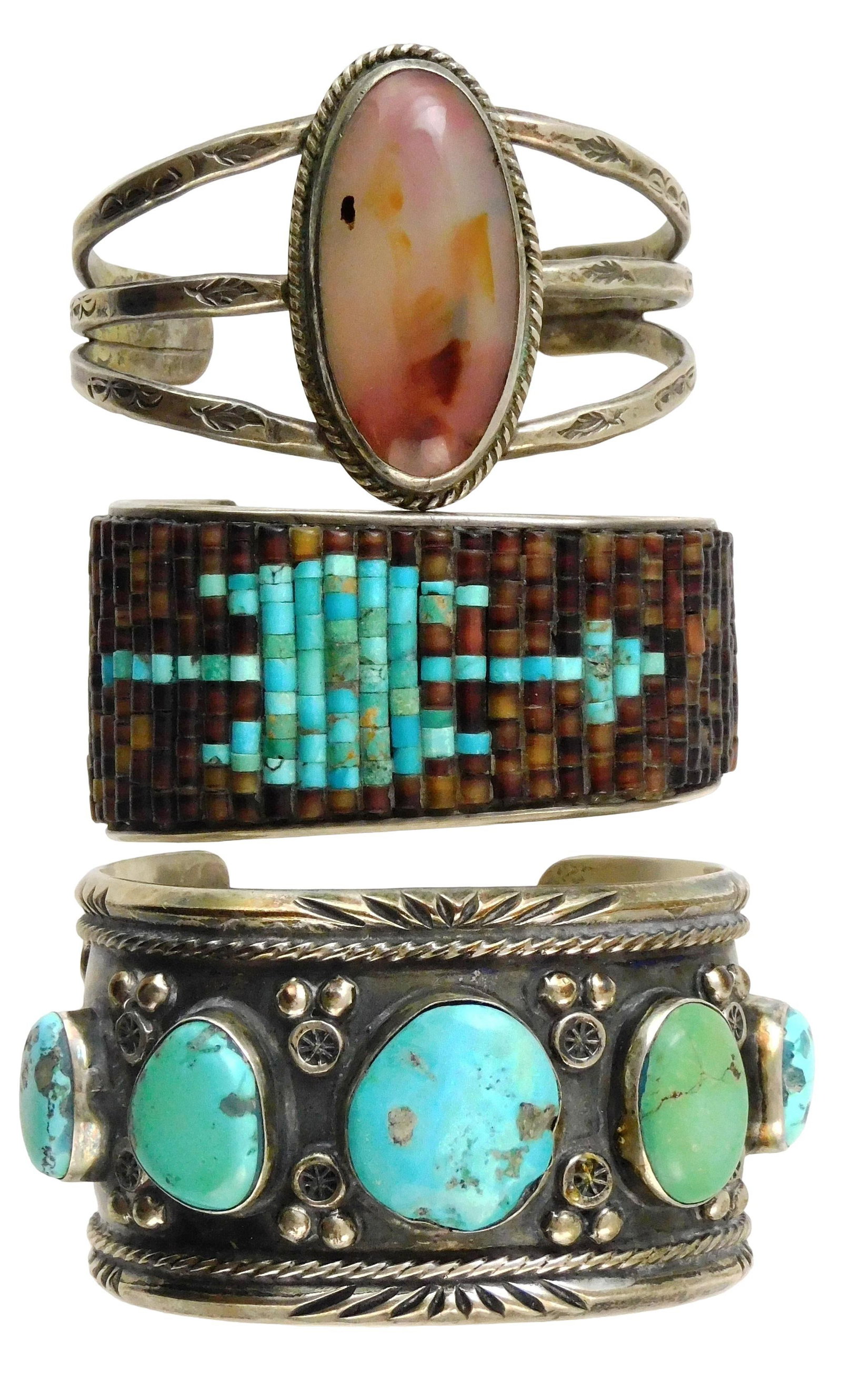 JEWELRY: Three Native American southwest cuffs, tested silver, including a large central oval agate: JEWELRY: Three Native American southwest cuffs, tested silver, including a large central oval agate cuff; a cuff with brown and blue rows of beads creating a pattern, stamped with a bird on back; and 