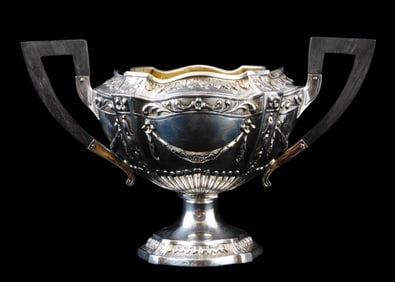 SILVER: German repousse footed bowl with wooden handles, floral design with swags and scrolled