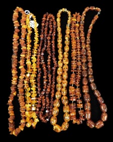 JEWELRY: Six amber or amber type necklaces, two with graduated oblong beads, four with nugget or