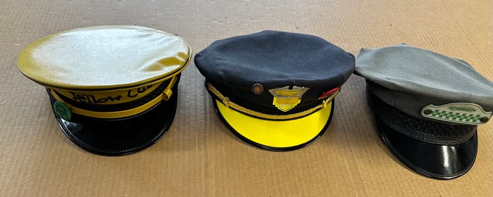 Three taxi drivers caps - two Yellow Cab, one Checker cab, some pins and badges on caps, vg