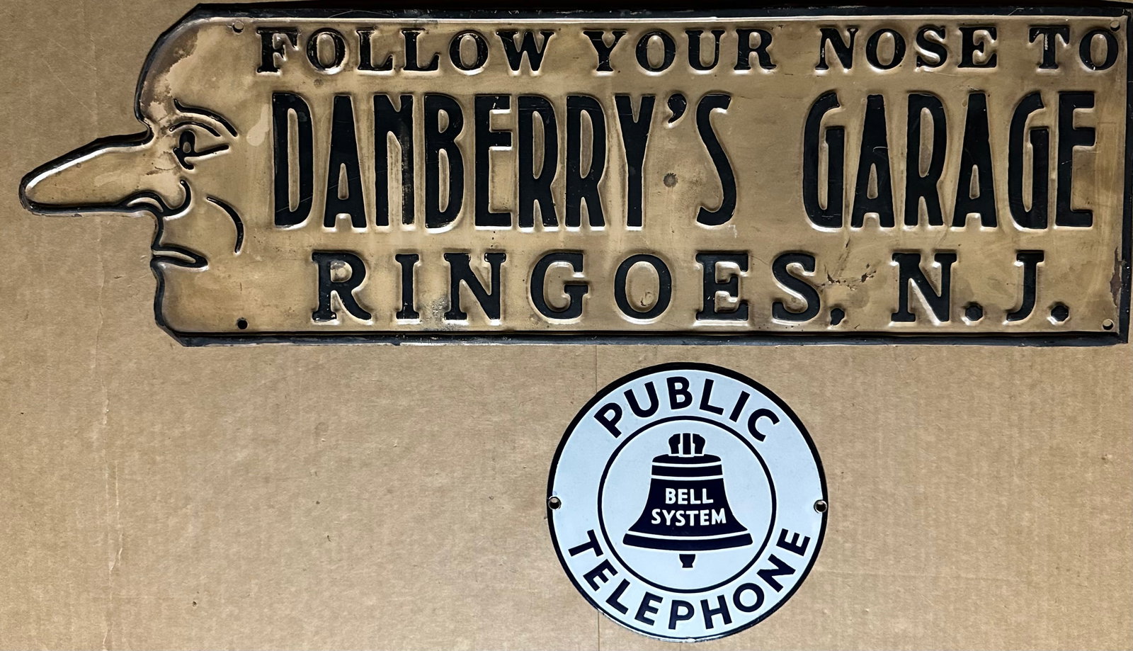 Two signs - Danberry’s Garage, die formed tin, 27 x 8, gd cond and seven inch dia porcelain (1 of 2)